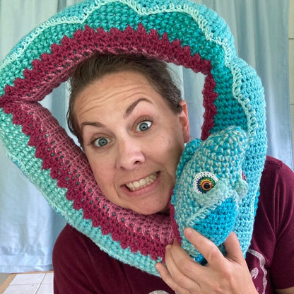 Large snake doll wrapped around a woman's head