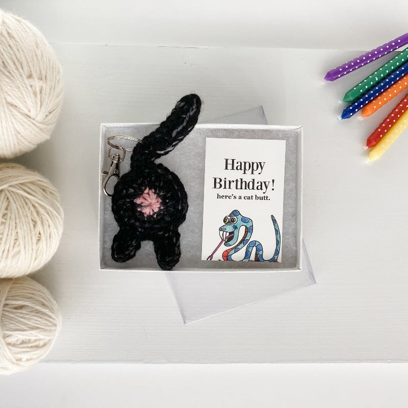black cat butt keychain and snake birthday card in a white box with a clear top wholesale packaging