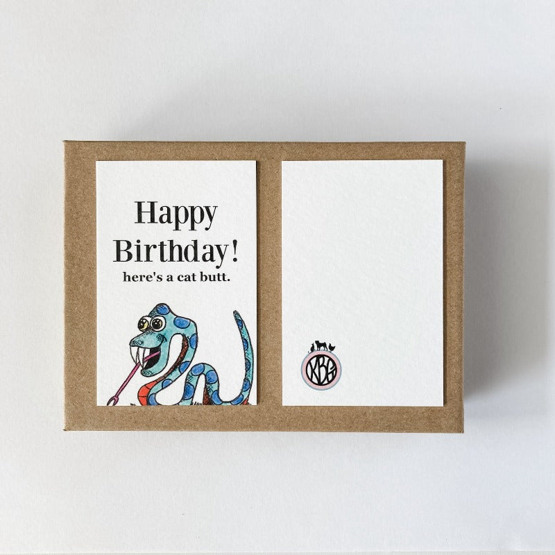 Knot By Gran'ma illustrated snake birthday art card front and back on a Kraft box