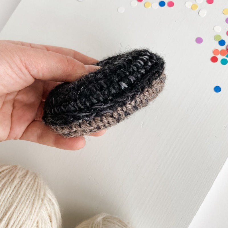 Scale photo of dark chocolate crochet catnip plush donut
